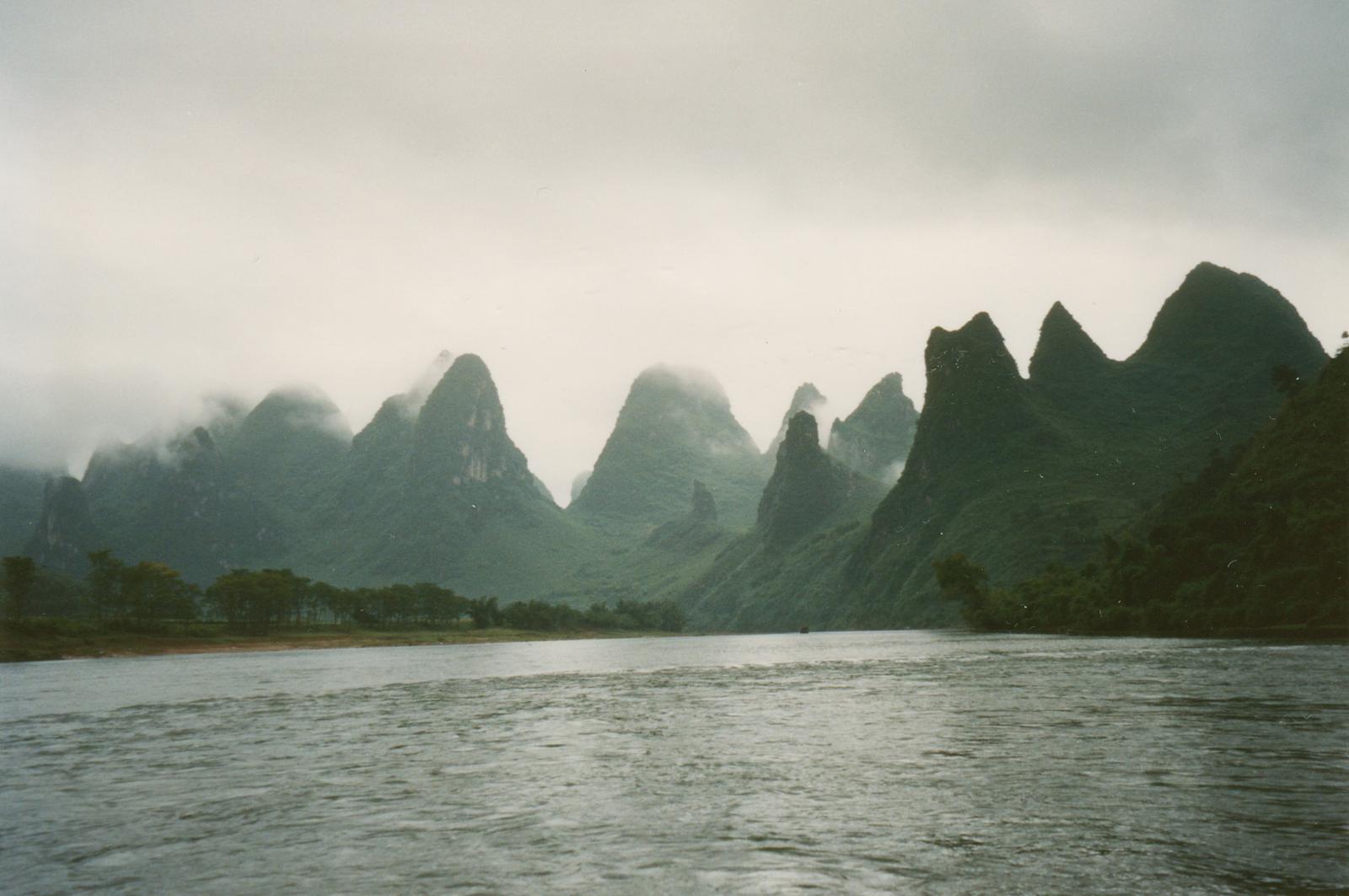 Karst peaks rising out of mist along the Li River near Guilin